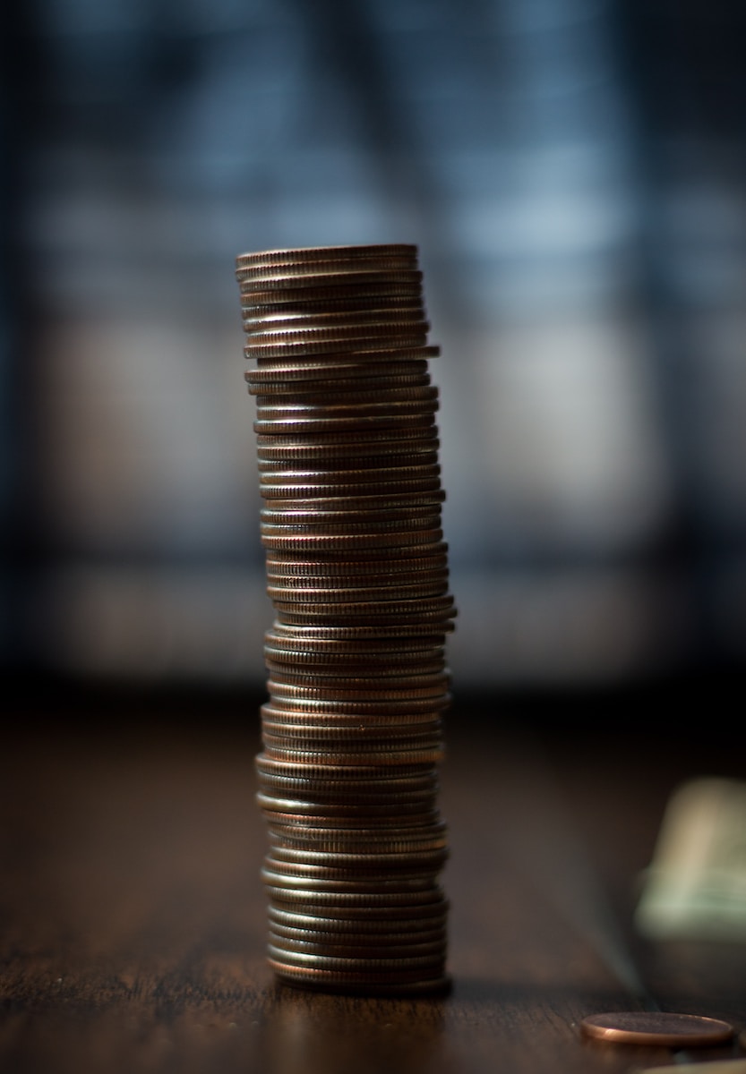 Photo by Matthew Lancaster gold round coins on brown wooden table